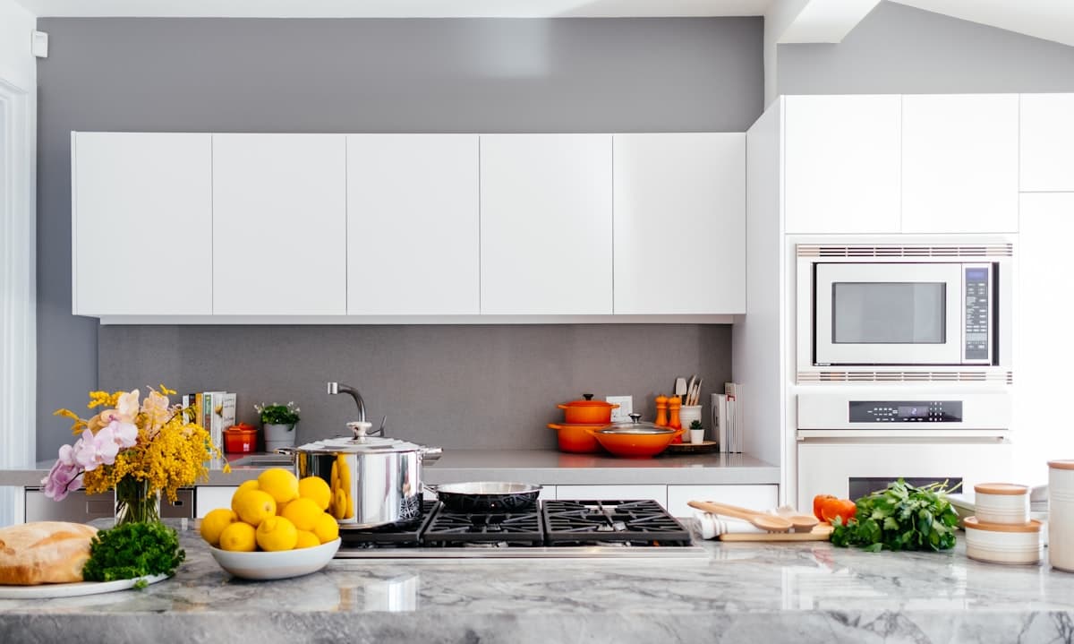 Bright grey and white kitchen with a gas cooktop, the kind of stove we clean across Sydney